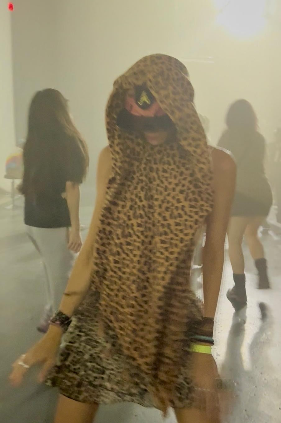 Dancing at a festival in the cheetah print poncho scarf worn as a head wrap