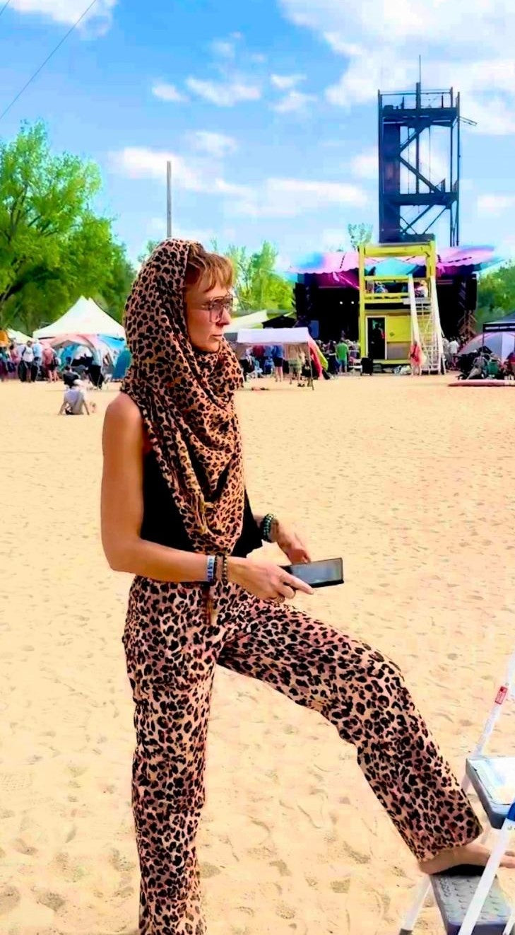 Harmonee wearing the cheetah print poncho scarf as a head wrap