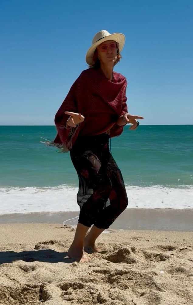 Red Cozy Fuzzy poncho scarf worn at the beach
