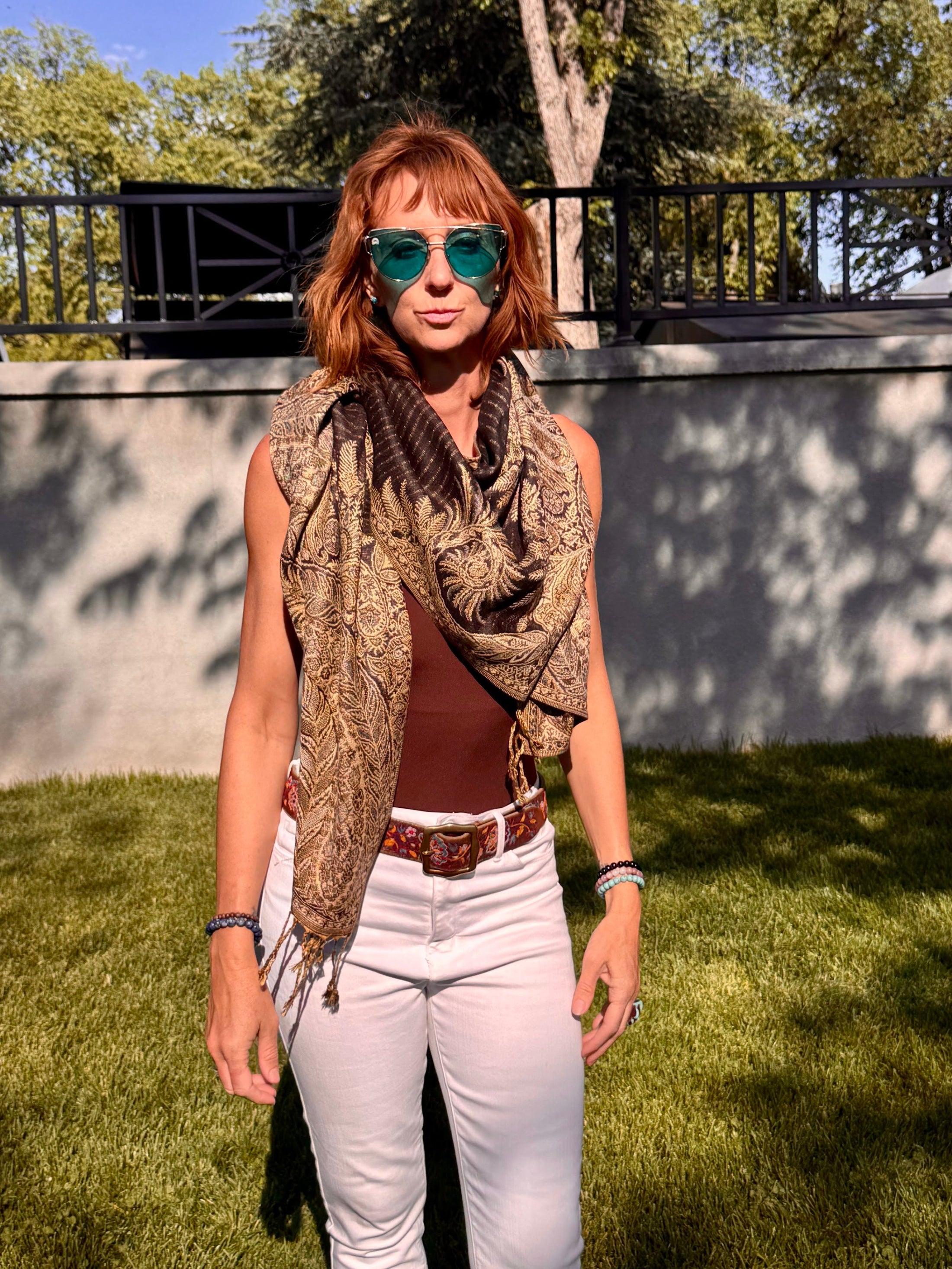 Black poncho scarf draped around the shoulders as a scarf