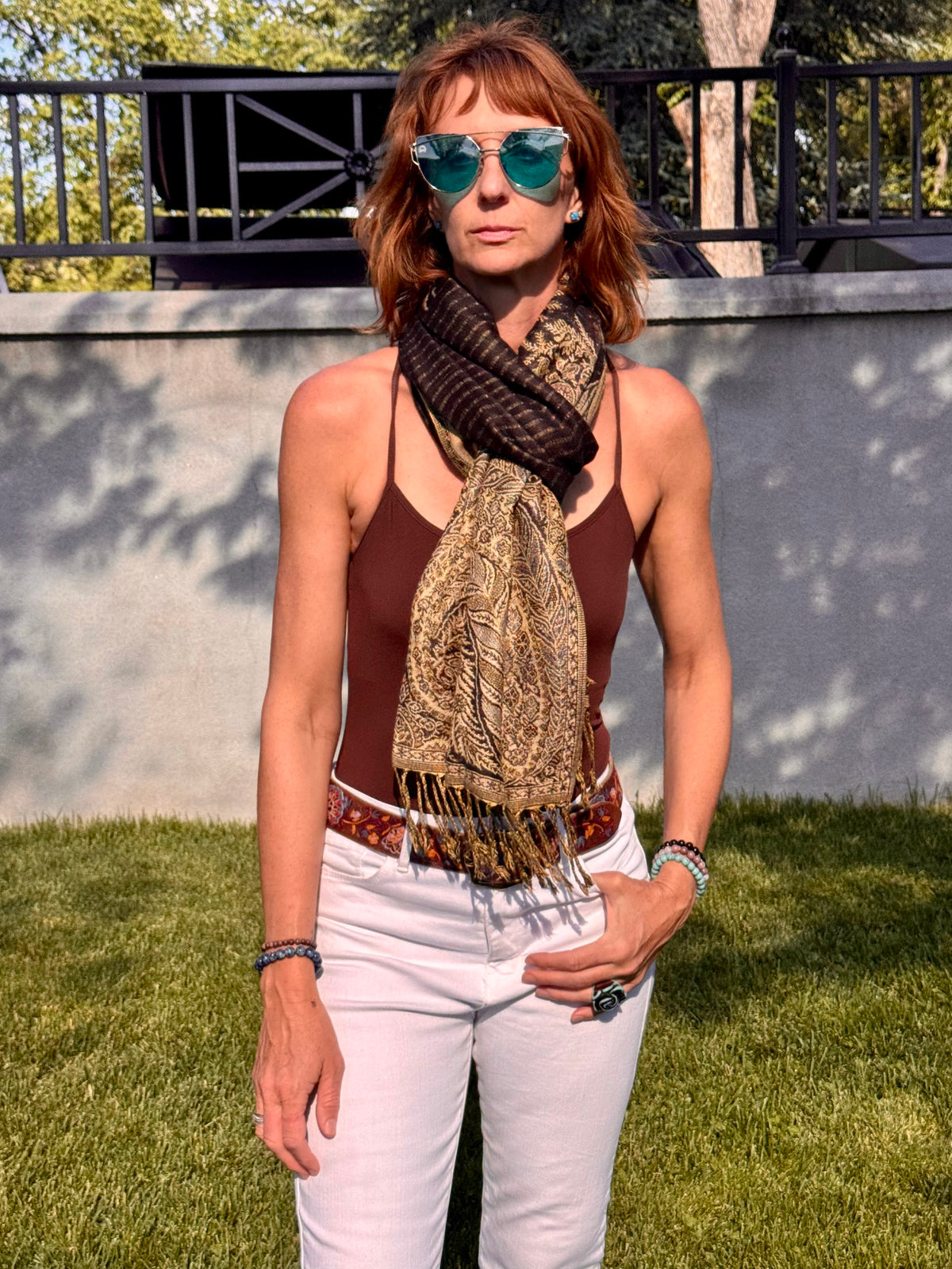 Black poncho scarf looped at the neck and worn as a scarf