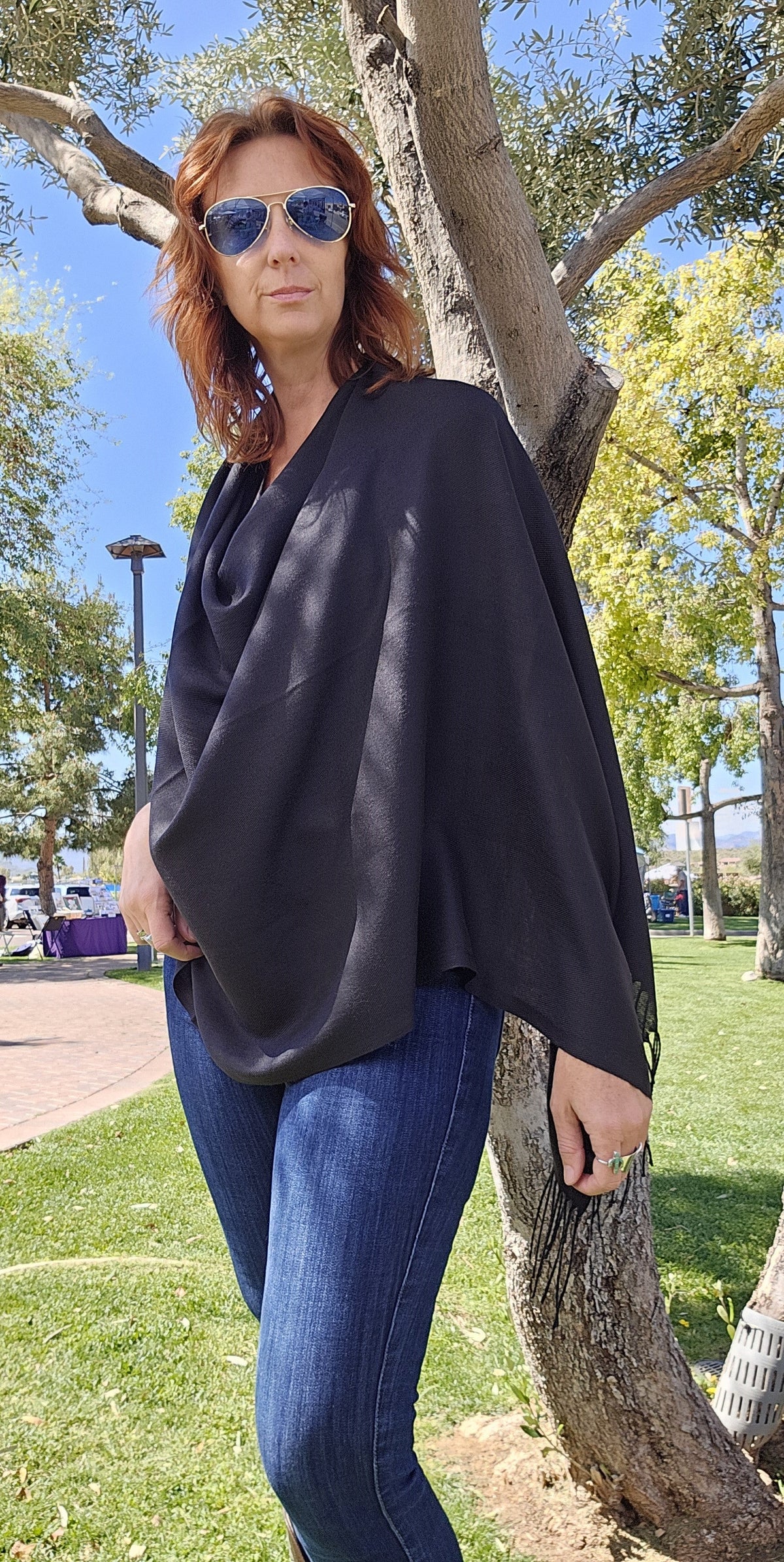 Black poncho scarf worn with the seam at the back for a clean front line
