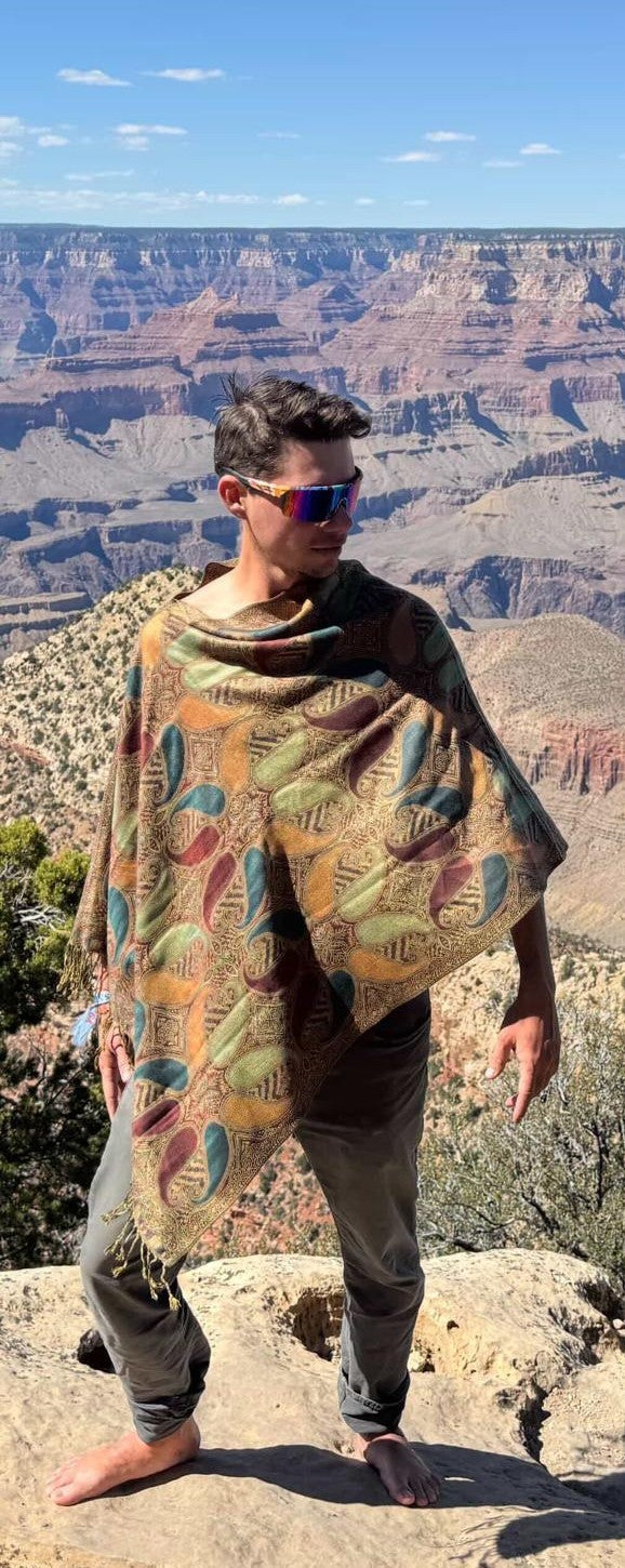 Traveller wearing the teal and brown Large Paisley poncho scarf