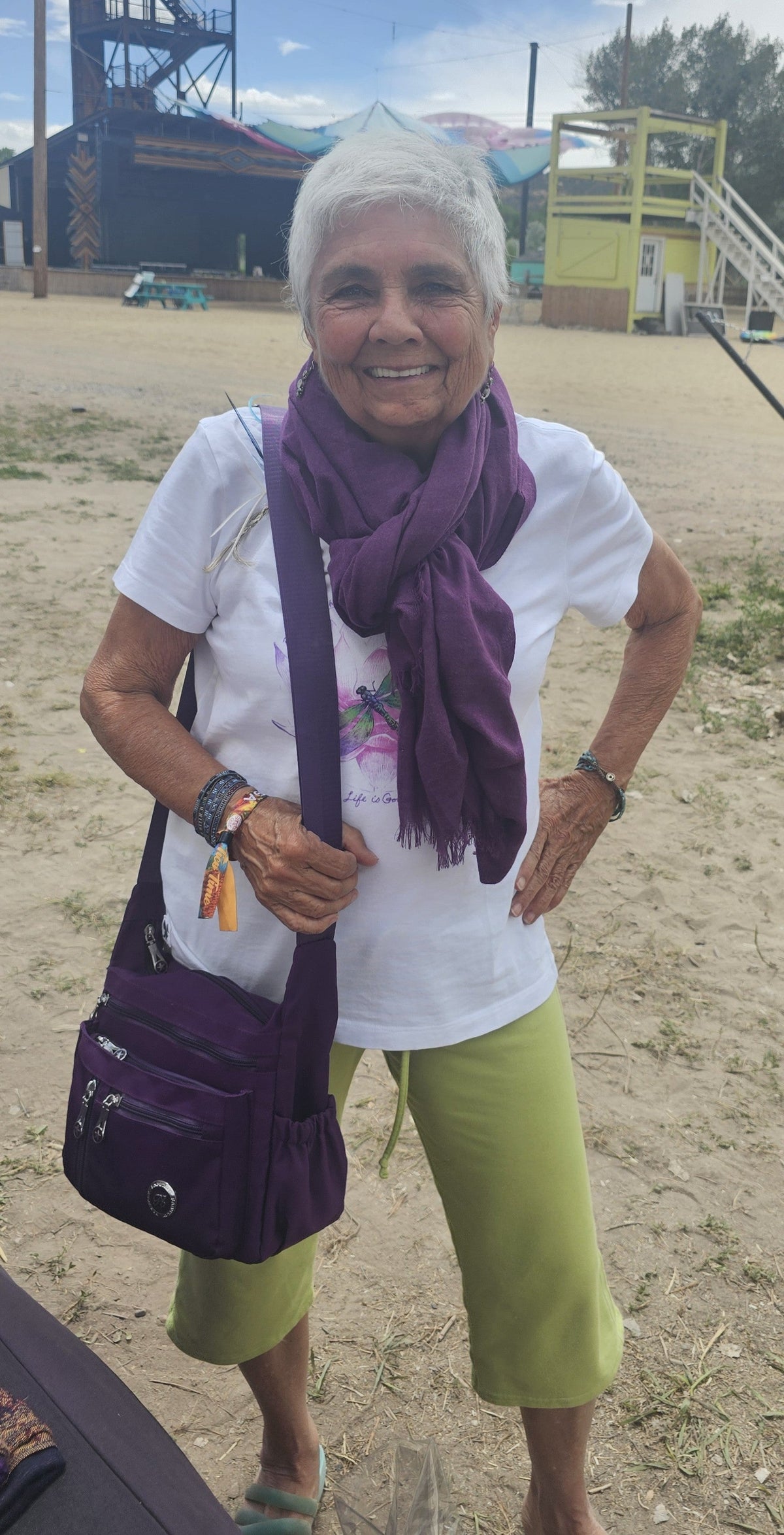 Customer wearing the eggplant lightweight poncho scarf looped as a scarf