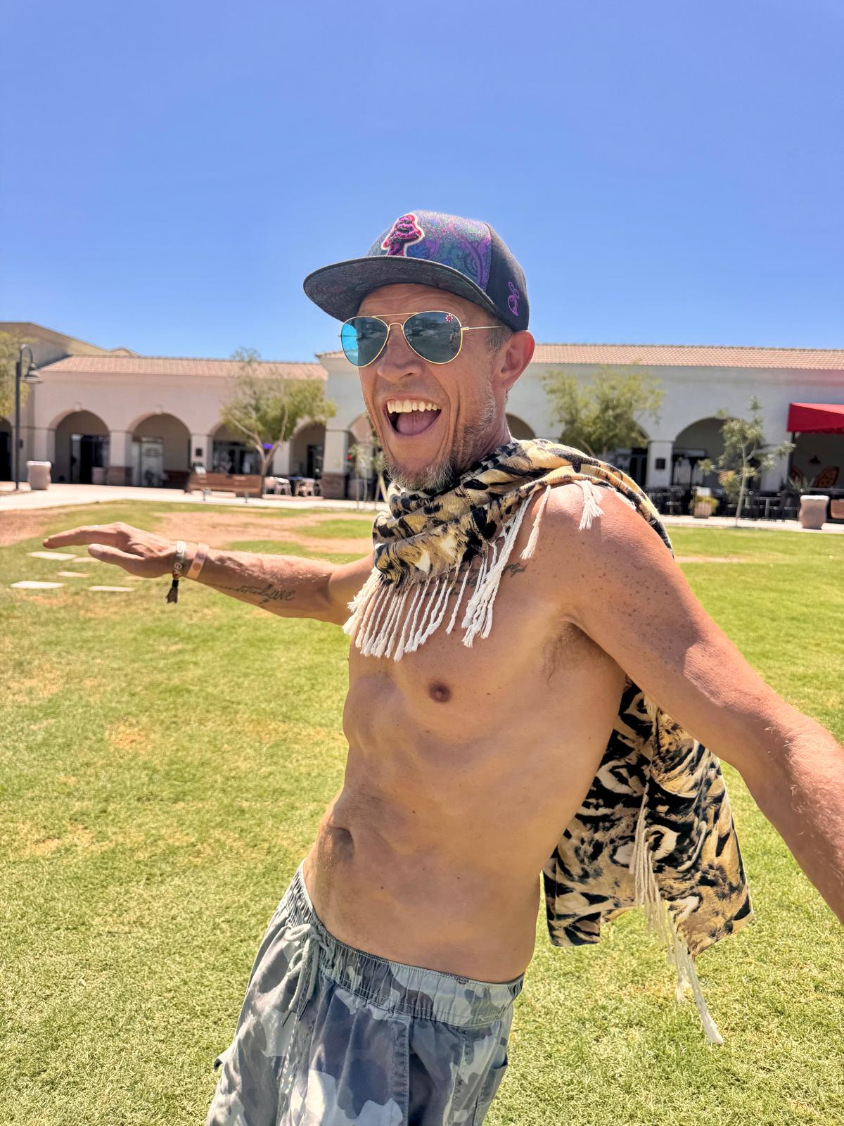 Owl Feather poncho scarf caught in motion, worn open like a cape