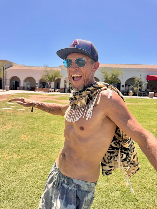 Owl Feather poncho scarf caught in motion, worn open like a cape
