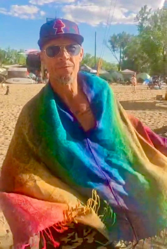 Model dancing in the Rainbow Paisley poncho scarf at a festival