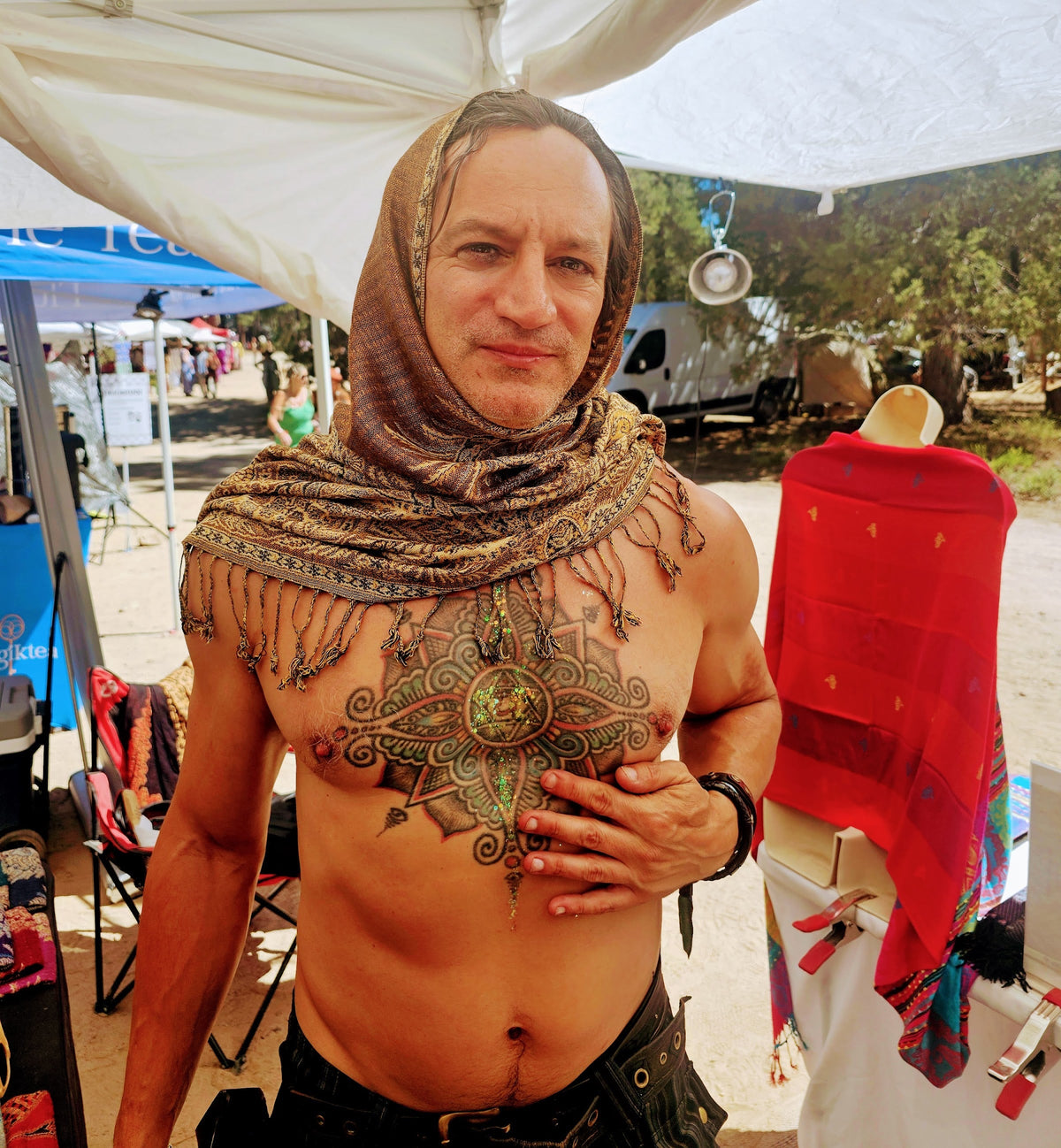 Festival goer wearing the copper Semi Solid poncho scarf as a head wrap
