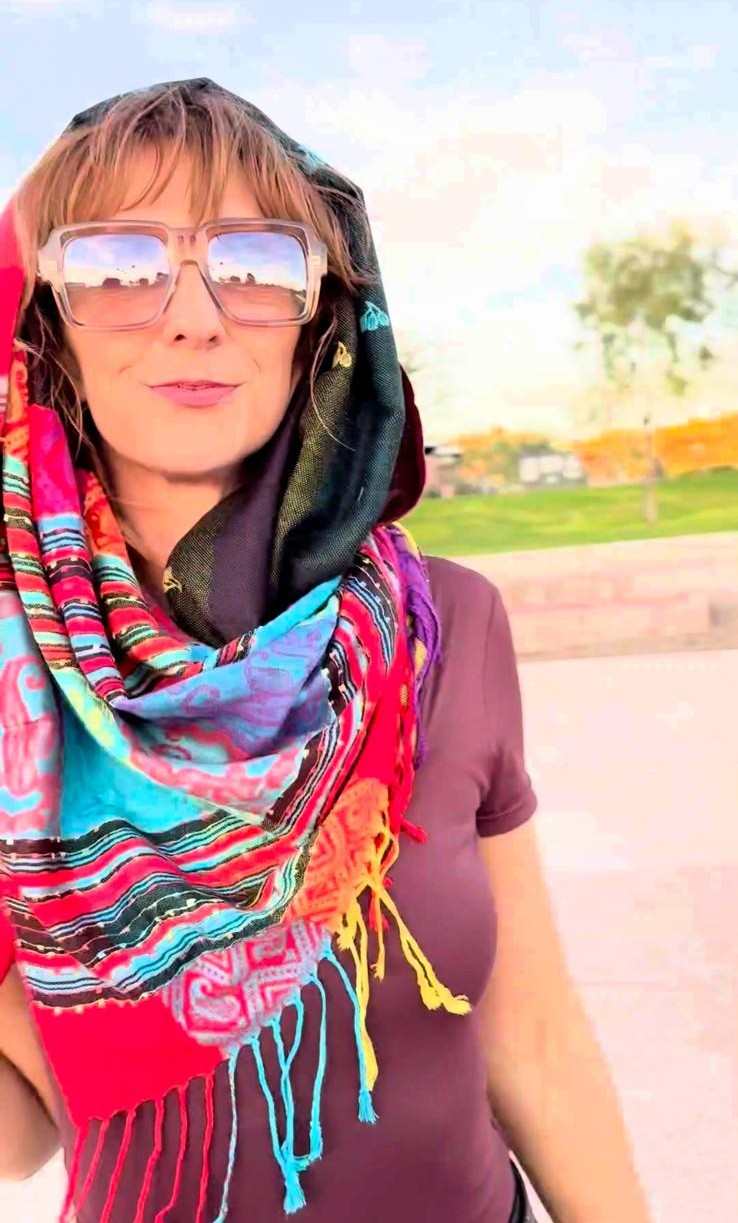 Striped poncho scarf worn as a festival head wrap